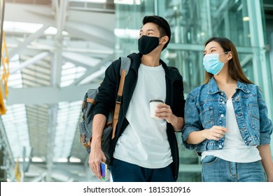 Young Asian Male And Female Couple Tourists Drag Luggages Walking Through The Hallway After Arrival ,two Asian People Traveller Wearing Facial Face Mask Virus Protection Safety Travel Ideas Concept