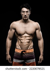 Young Asian Male Fitness Model Poses On Studio Over Dark Background On 18 November 2015. Photo By Victor Fraile