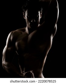 Young Asian Male Fitness Model Poses On Studio Over Dark Background On 18 November 2015. Photo By Victor Fraile