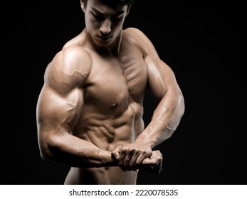 Young Asian Male Fitness Model Poses On Studio Over Dark Background On 18 November 2015. Photo By Victor Fraile