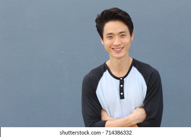 Young Asian Male Smiling And Laughing With Arms Crossed