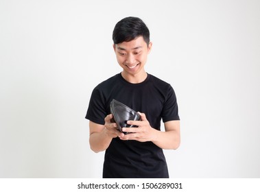 Young Asian Man Black Shirt Look At Cash In His Wallet With Smile And Feel Happy And On White Isolated,Rich Man Concept