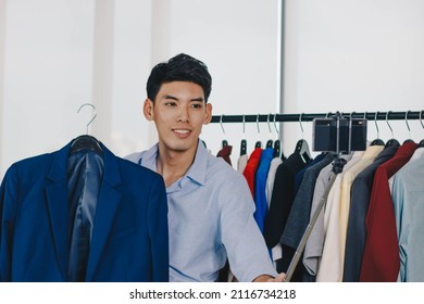 Young Asian Man Blogger Is Broadcasting A Video For Selling Clothes Online.