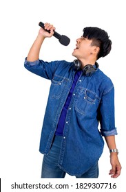 Young Asian Man In Blue Jean Singing With Microphone. Portrait On White Background With Studio Light.