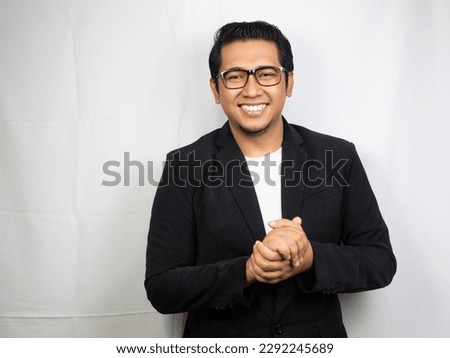 young Asian man clasping both hands