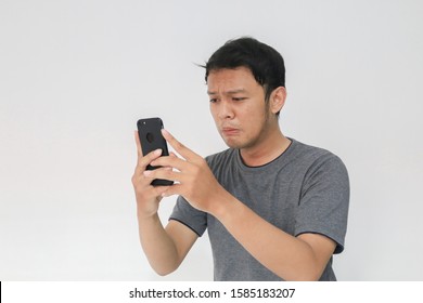 Young Asian Man Cry And Sad When Looking On The Smartphone