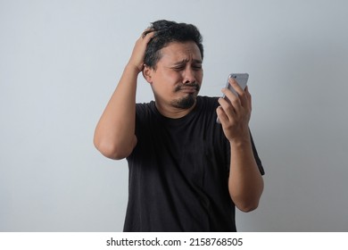 Young Asian Man Crying While Looking Phone