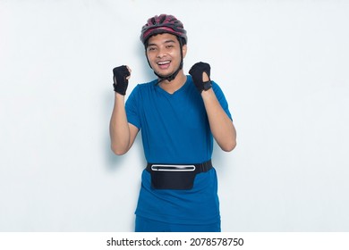 Young Asian Man Cyclist Shaking Fists Isolated On White Background
