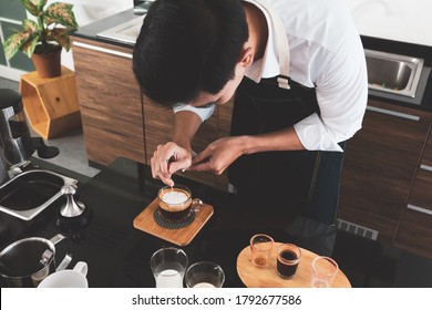 Young Asian Man Doing The Art Latte In The Restaurant. Barista And Coffee Cafe Concept