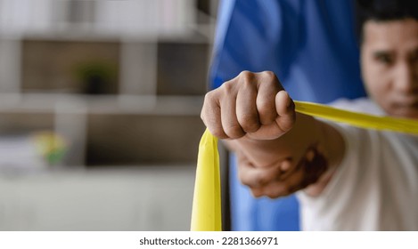 Young Asian man doing physiotherapy and seeking advice from muscle pain with shoulder, limbs in rehabilitation center. - Powered by Shutterstock