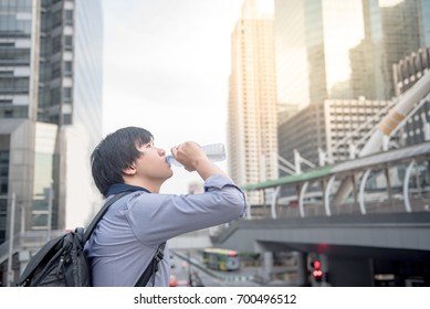 Young Asian Man Drinking A Bottle Of Water In The City, Urban Healthy Lifestyle Concepts