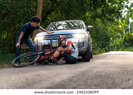 Young Asian man driving a car crashes into a cyclist falls and injures his knee, Cyclist in need of urgent aid, Unexpected Roadside Encounter and Immediate Assistance for Outdoor Mishaps Car Crash.