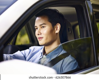 Young Asian Man Driving A Vehicle.