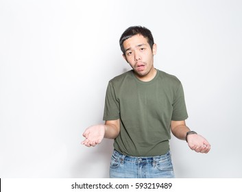 young asian man early adult age shrugged to express doubt, ignorance or indifference with absurd face expression, studio shot white background