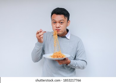 Young Asian Man Enjoy Noodles. Eating Lunch Concept.