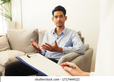 Young Asian Man Explaining His Problems About Mental Disorder During Psychological Session With Psychiatrist To Seek Advice And Therapy. Mental Disorder Consultation And Healthcare Concept