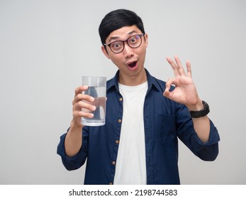 Young Asian Man Gentle Smile Hold Glass Of Water Show Hand Ok Isolated