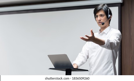 Young Asian Man Giving A Presentation In A Conference Room