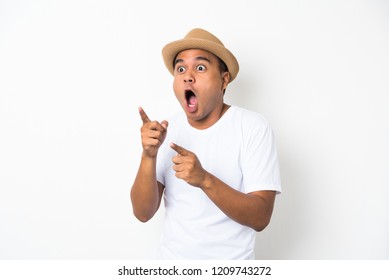 Young Asian Man With Hat Feels Shock And Surprise With Overly Face Expression And Looking On Blank Space.