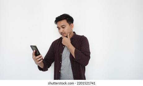  Young Asian Man Holding Chin Looking Sideways                              