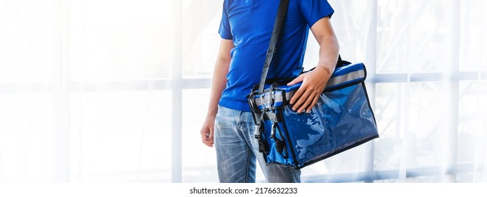 Young Asian Man Holding Food Bag And Standing Inside Of The Studio, Delivery Box Concept.