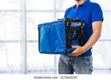 Young Asian Man Holding Food Bag And Standing Inside Of The Studio, Delivery Box Concept.