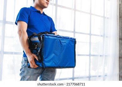 Young Asian Man Holding Food Bag And Standing Inside Of The Studio, Delivery Box Concept.