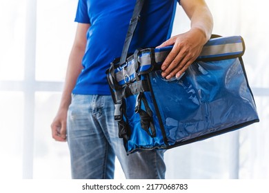 Young Asian Man Holding Food Bag And Standing Inside Of The Studio, Delivery Box Concept.