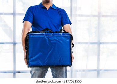 Young Asian Man Holding Food Bag And Standing Inside Of The Studio, Delivery Box Concept.