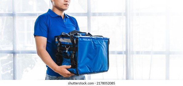 Young Asian Man Holding Food Bag And Standing Inside Of The Studio, Delivery Box Concept.