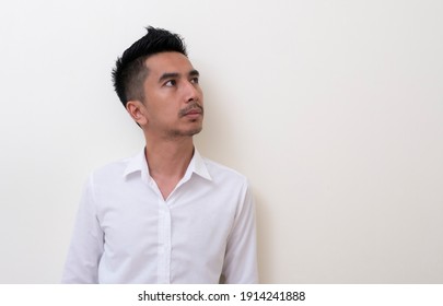 Young Asian Man Isolated On White Background Looking Sideways