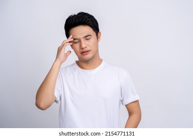 Young Asian Man Isolated On White Background Touching Temples And Having Headache.