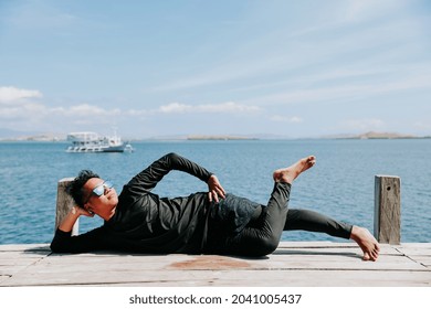 Young Asian Man Lying Down And Relaxing Enjoying The Atmosphere Of The Sea