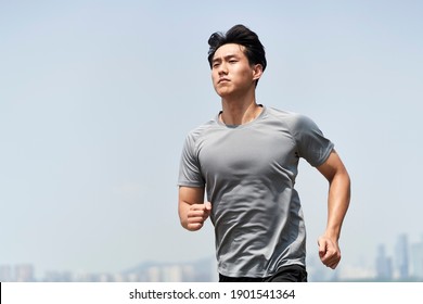 young asian man male runner jogger running jogging outdoors - Shutterstock ID 1901541364