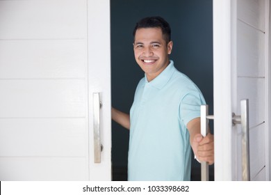 Young Asian Man Open His Front House Door And Smiling