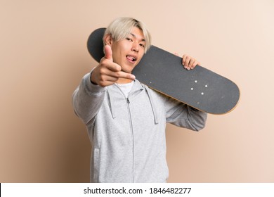 Young Asian Man Over Isolated Background With Skate