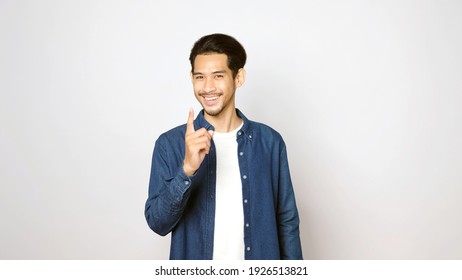 Young Asian Man Pointing Finger Gesture, Smiling And Looking At Camera While Standing Over Isolated Grey Background With Copy Space, Banner, Asia Guy In Positive Expression 