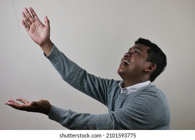 Young Asian Man Preparing To Get Something With Both Hands Smiling And Looking Happy