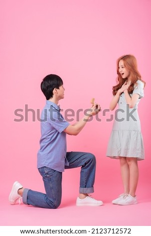 Young Asian man proposes to his girlfriend on a pink background
 Foto stock © 