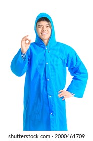 Young Asian Man In Raincoat Showing OK On White Background