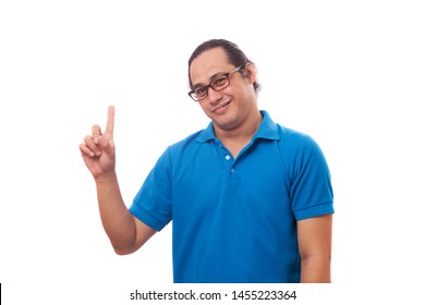 Young Asian man raising pointing finger, number one gesture, pick me concept, isolated on white