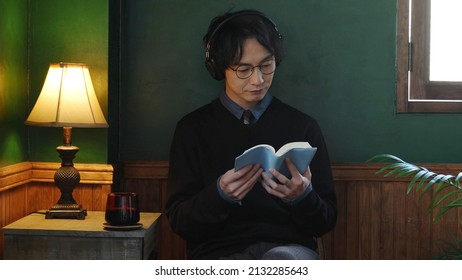 young asian man reading book in the antique room
