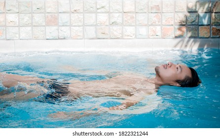 Young Asian Man Relax And Spa In Swiming Pool.