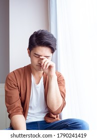 Young Asian Man Rubbing His Eyes