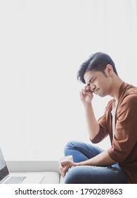 Young Asian Man Rubbing His Eyes