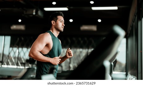 Young Asian Man Running on Treadmill - Fitness Gym Exercise - Powered by Shutterstock