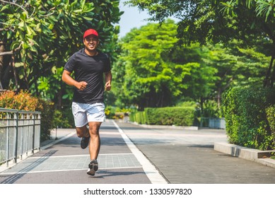 Young asian man running in the urban city with copy space. Fitness, workout, sport, lifestyle concept.