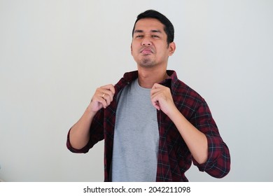 Young Asian Man Showing Arrogant Gesture While Touching His Shirt