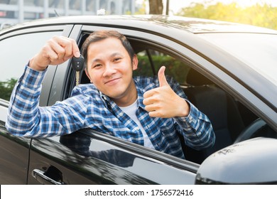 Young Asian Man Showing Thumb Up And Hand Holding His Key In The Car. Concept Of Rent Car Or Buying Car.