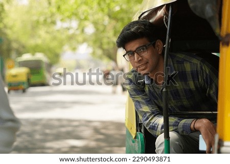 Young asian man  sitting in auto rickshaw